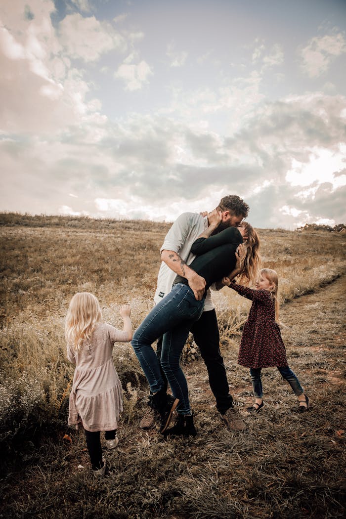 A joyful family shares a loving moment outdoors, surrounded by nature.